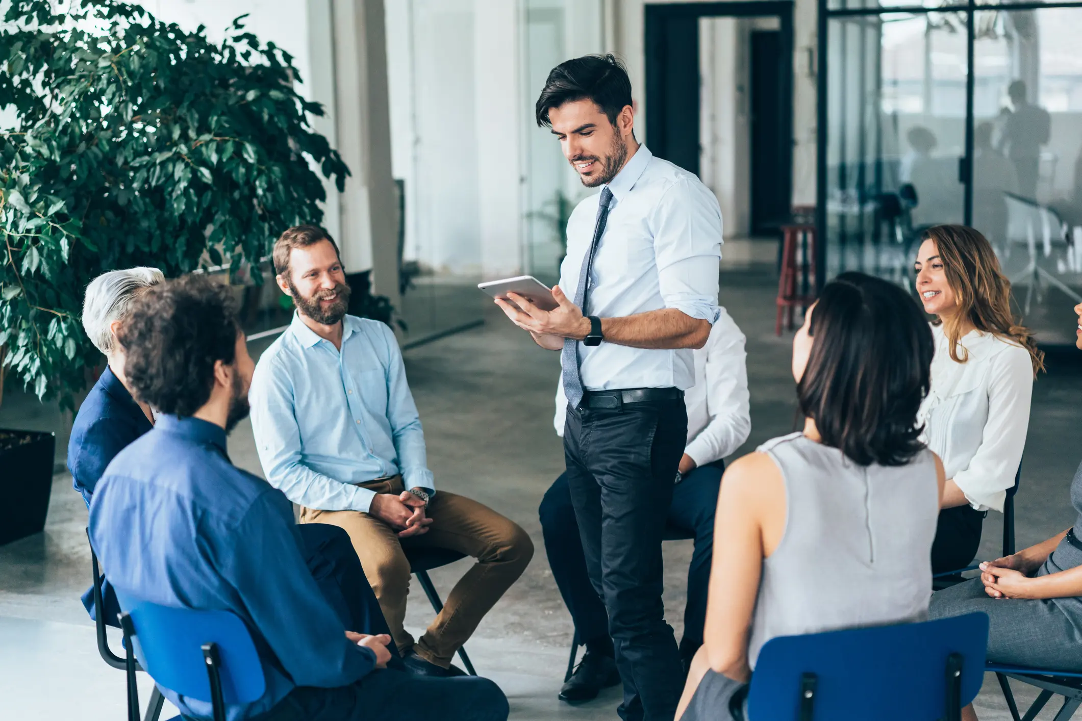 Happy CEO giving his team a business presentation in a board room