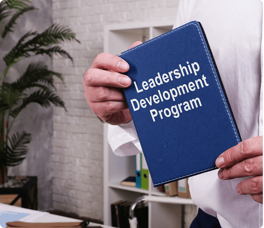 Leadership program booklet held by person